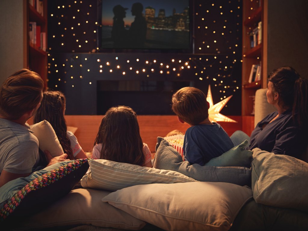 family of four on pillows watching on the best texas tv shows